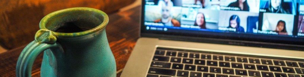 Coffee cup next to a ketboard